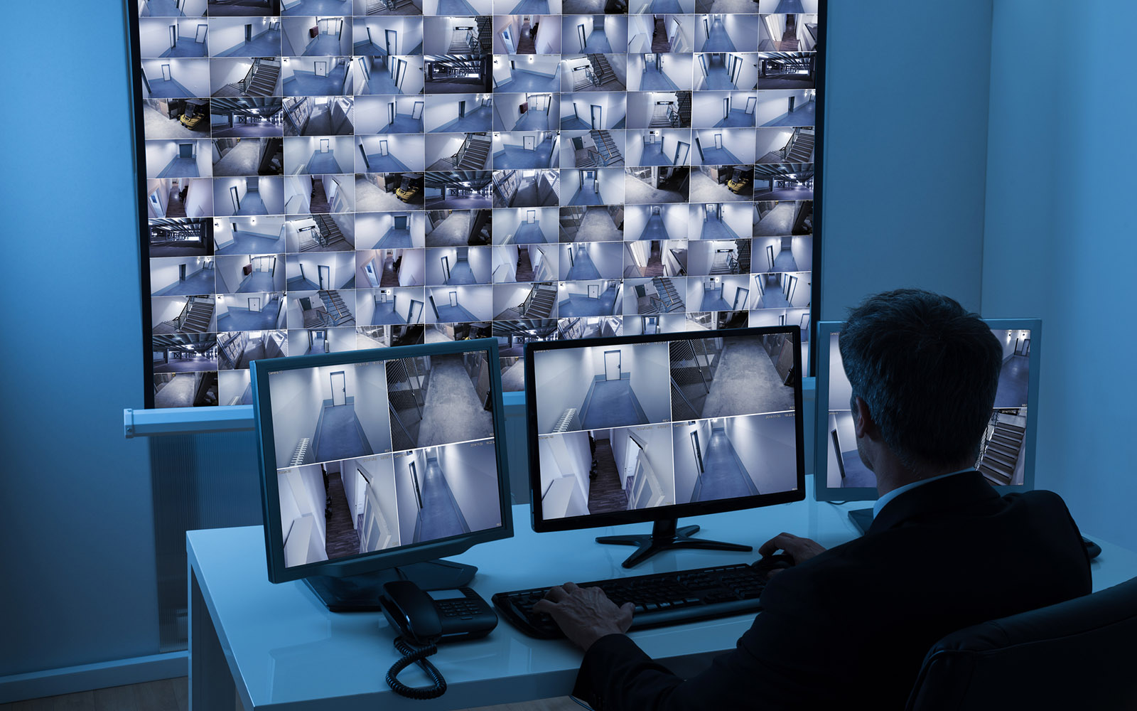 Man In Control Room Monitoring Cctv Footage